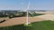 Aerial drone view of wind trubines and green and yellow fields in Normandy, France