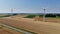 Aerial drone view of wind trubines and green and yellow fields in Normandy, France