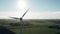 Aerial drone view windmills wind turbines producing clean ecological electricity by road in green agricultural fields on