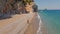 Aerial drone view woman traveler walking alone by Empty Wild secret beach in bay close to Antalya. Sandy beach and clear