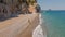 Aerial drone view woman traveler walking alone by Empty Wild secret beach in bay close to Antalya. Sandy beach and clear