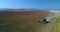 Aerial drone view of working agricultural combine on harvest field