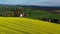 Aerial drone view of yellow rapeseed fields in German countryside.