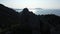 Aerial drone view of young active mountaineers man and woman on a summit in Crimea. Silhouettes of a young loving couple