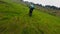 Aerial dynamic view motorbike enduro rider speed driving standing rural meadow