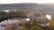 Aerial early cold sunny autumn morning view of trees and lake. Fall outdoor scenery.