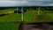 Aerial elevated partial orbit clip of rural wind turbines in the English countryside