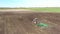 Aerial Elevated View.Tractor Plowing Field. Beginning Of Agricultural Spring Season. Cultivator Pulled By A Tractor In