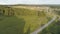 Aerial of the empty road going through forest, summer nature landscape. Scene. Flying above the highway through the