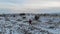 Aerial epic mountain landscape view of woman trekking  at valley covered with snow in Cappadocia