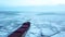 Aerial epic red ship in winter sails through frozen sea makes its way. Ice floe graphic pattern. Specialized vessel for