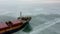 Aerial epic red ship in winter sails through frozen sea makes its way. Ice floe graphic pattern. Specialized vessel for