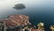 Aerial establishing view of old town of Dubrovnik with island on Adriatic sea, Dalmatia, Croatia. Medieval city fortress