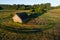 An aerial of Estonian countryside with an old wooden barn and White stork