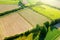 Aerial european countryside landscape at sunset. Drone point view of agricultural fields, roads, copses