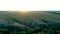 Aerial evening sunshine view of spacious field