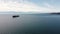 Aerial Evergreen container ship anchored off Vancouver Island with the Washington state Olympic mountains at background.