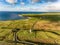 Aerial Famous Irish Tourist Attraction In Doolin, County Clare, Ireland. Doonagore Castle is a round 16th-century tower Castle.