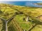 Aerial Famous Irish Tourist Attraction In Doolin, County Clare, Ireland. Doonagore Castle is a round 16th-century tower Castle.