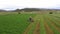 Aerial farm agriculture swather cutting alfalfa hay 4K