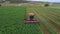 Aerial Farm field swather cutting alfalfa hay pull 4K