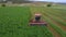 Aerial Farm field swather cutting alfalfa hay pull fast motion 4K