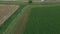 Aerial farm green alfalfa hay field harvest barn climb 4K