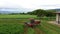 Aerial farm green alfalfa hay field swather turns 4K