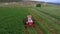 Aerial farm tractor cutting hay farmer swather circle 4K