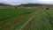 Aerial farm tractor cutting hay for livestock circle 4K
