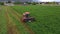 Aerial farm tractor cutting hay for livestock farmer broke 4K