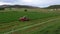 Aerial farm tractor cutting hay for livestock farmer fixing 4K