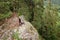 Aerial of female adventure hiker reaching top