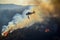 Aerial firefighting Helicopter releases water to combat a fierce wildfire