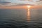 Aerial from a fishing boat on the North Sea and freighters at the horizon at sunset in the Netherlands