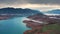 Aerial flight Beautiful spring landscape of river with blue turquoise water and hills against background of mountains