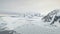 Aerial flight over Antarctica mountains, ocean.