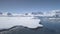 Aerial flight over Antarctica shoreline, ocean.