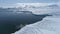 Aerial flight over Antarctica snow land, ocean.