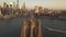 AERIAL: Flight over Brooklyn Bridge with American flag waving and East River view over Manhattan New York City Skyline