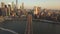 AERIAL: Flight over Brooklyn Bridge with view over Manhattan New York City Skyline at Sunset in beautiful