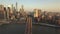 AERIAL: Flight over Brooklyn Bridge with view over Manhattan New York City Skyline at Sunset in beautiful