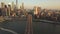 Aerial: flight over Brooklyn Bridge with view over Manhattan New York City Skyline at Sunset in beautiful