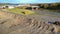 Aerial flight over huge silage pits with operating machinery