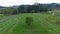 Aerial flight over men mowing hay crop