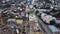 Aerial Flight Over a New Constructions Development Site with Diverse Heavy Machinery and Construction Workers are