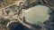 Aerial flight over settling tanks production drone from a bird`s eye view over a dirty lake swamp near the corn starch plant.