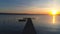 Aerial flight over small dock and boat at the lake