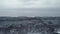 Aerial flight in winter spruce and pine forest. Trees are frozen and covered with snow. Snowy background fir branches