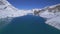 Aerial fly over beautiful blue Tilicho lake in high altitude Himalaya mountains range with clear blue skies background